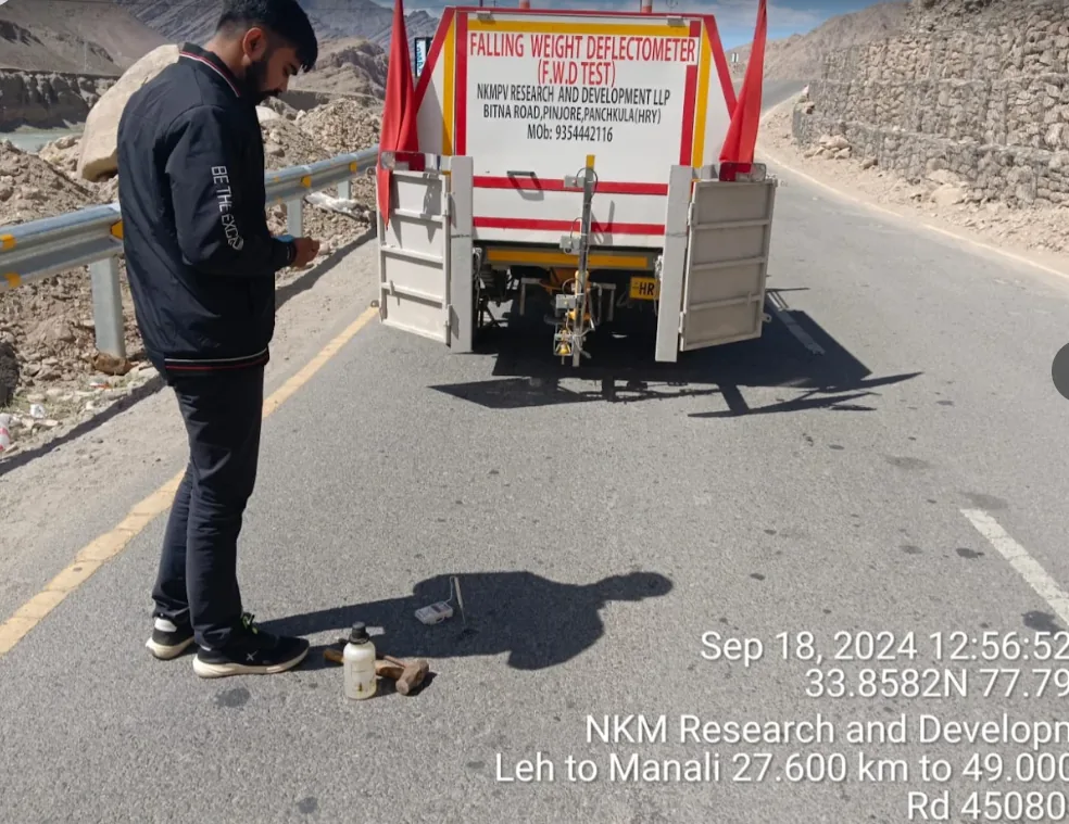 NKMPV Falling Weight Deflectometer load plate and deflection-basin geophone deployment on highway.