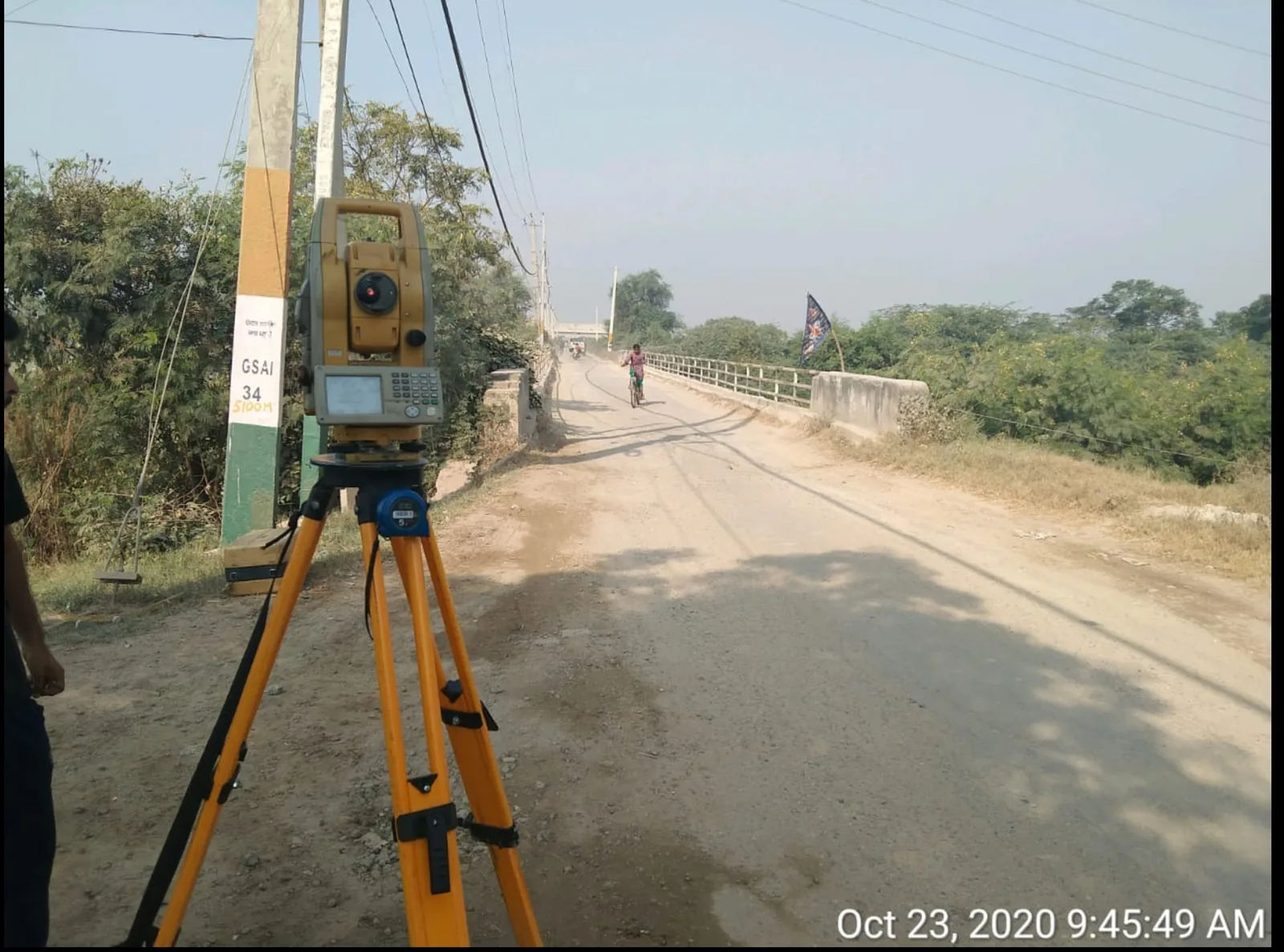 NKMPV Topcon total station on tripod at bridge approach during topographic survey.