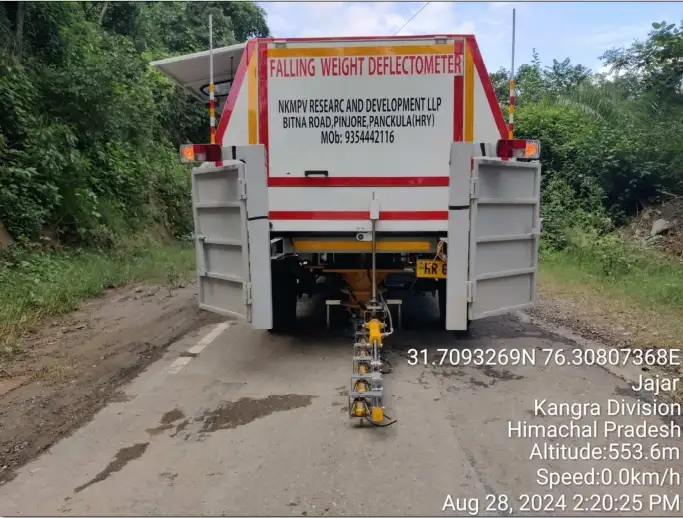 Falling Weight Deflectometer (FWD) test in progress for pavement structural evaluation on highway