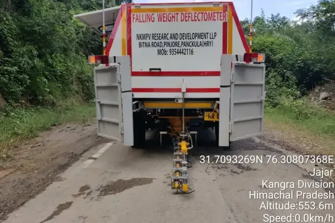 Falling Weight Deflectometer (FWD) test in progress for pavement structural evaluation on highway
